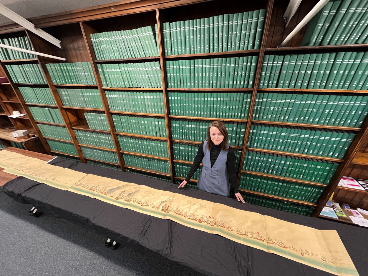 Leeds Central Library's naval battle: Leeds Central Library's senior librarian Rhian Isaac with sections of the step-by-step, illustrated account of the battles of Solebay and Texel which took place in the 1670s. Estimated to be more than 50 feet in length, the document itself dates from around 1908 and is among a collection of more than 3,000 books, pamphlets and periodicals donated by noted Leeds aristocrat, diplomat and naval history buff Sir Alvary Gascoigne.