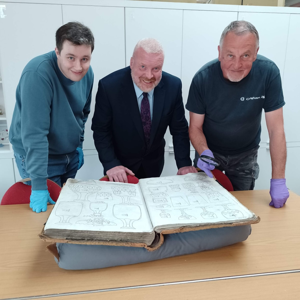 Museum research volunteers Joseph Round and Ian Fazey with Cllr Damian Corfield