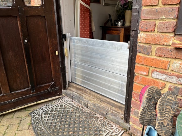 Council considers new flood protection scheme for homes: Flood prevention boards on a door of a house