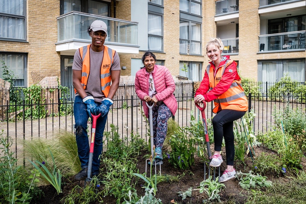 Three happy volunteers pose at the Packington Estate