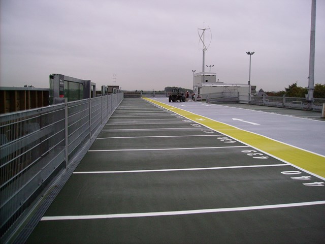 Stafford multi-storey car park: Finishing touches being put to the top deck. Shows one of two 'egg whisk' wind turbines at the car park.