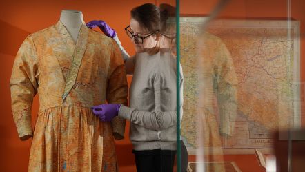 Assistant Textile Conservator, Stella Gardner adjusting a silk dress made from escape and evade maps used during the Second World War, on loan from Worthing Museum and Art Gallery. Image © Stewart Attwood