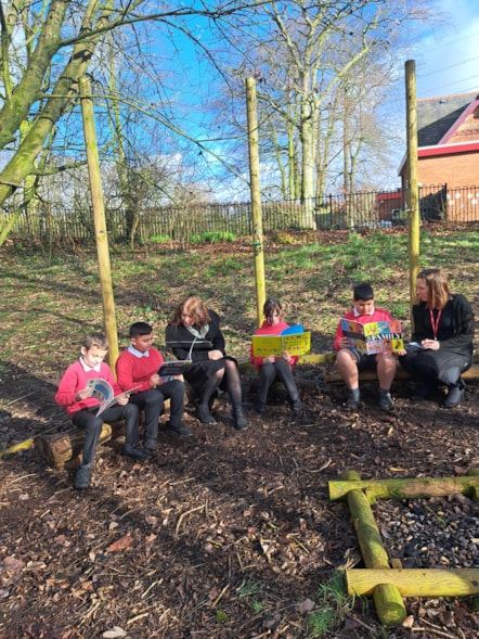 Pictured from left to right are pupils Manny and Ayush, headteacher Pam Maloney, pupils Abbie and Kaiyan and EAL team leader Roxana Sardais at the forest school at Howick Church of England Primary School.jpg