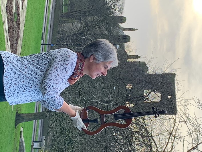 Sounds of Our City: Curator Kitty Ross with a specially-adapted violin which is on display in Sounds of Our City