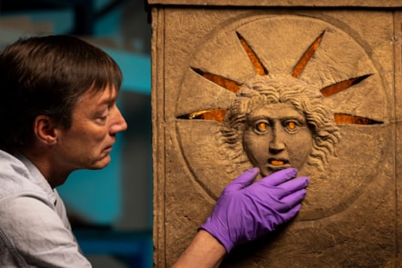 Curator Dr Fraser Hunter examines the Roman altars.Photo © Duncan McGlynn (4)
