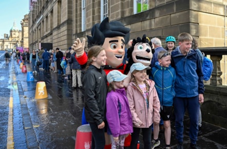 Beano fans have their photo taken with Dennis the Menace while they queue outside the National Library of Scotland's George IV Bridge building. The Library was giving away special centenary editions of the comic to mark the Library's 100 birthday, which fell on 7 August. Credit: Neil Hanna