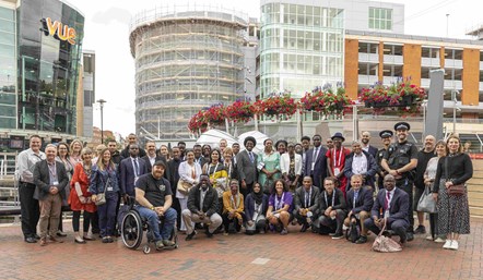 Delegates from the Commonwealth Conference on Youth Work at the Armoured Heart sculpture with partners responsible for the sculpture's creation