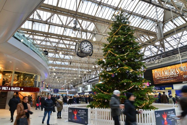 Majority of rail network open for business as usual over festive period as £120m upgrade takes place: Waterloo railway station concourse - with Christmas tree and clock