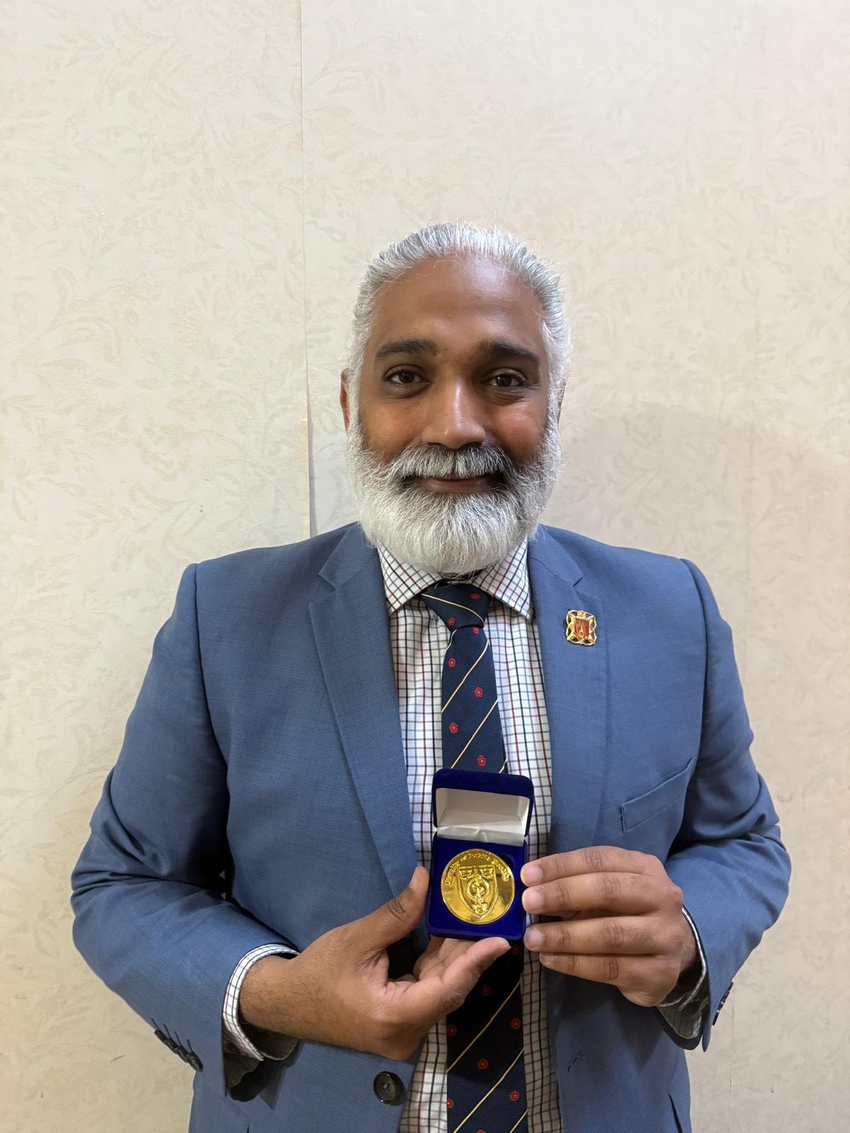 Dr Sakthi Karunanithi with his medal