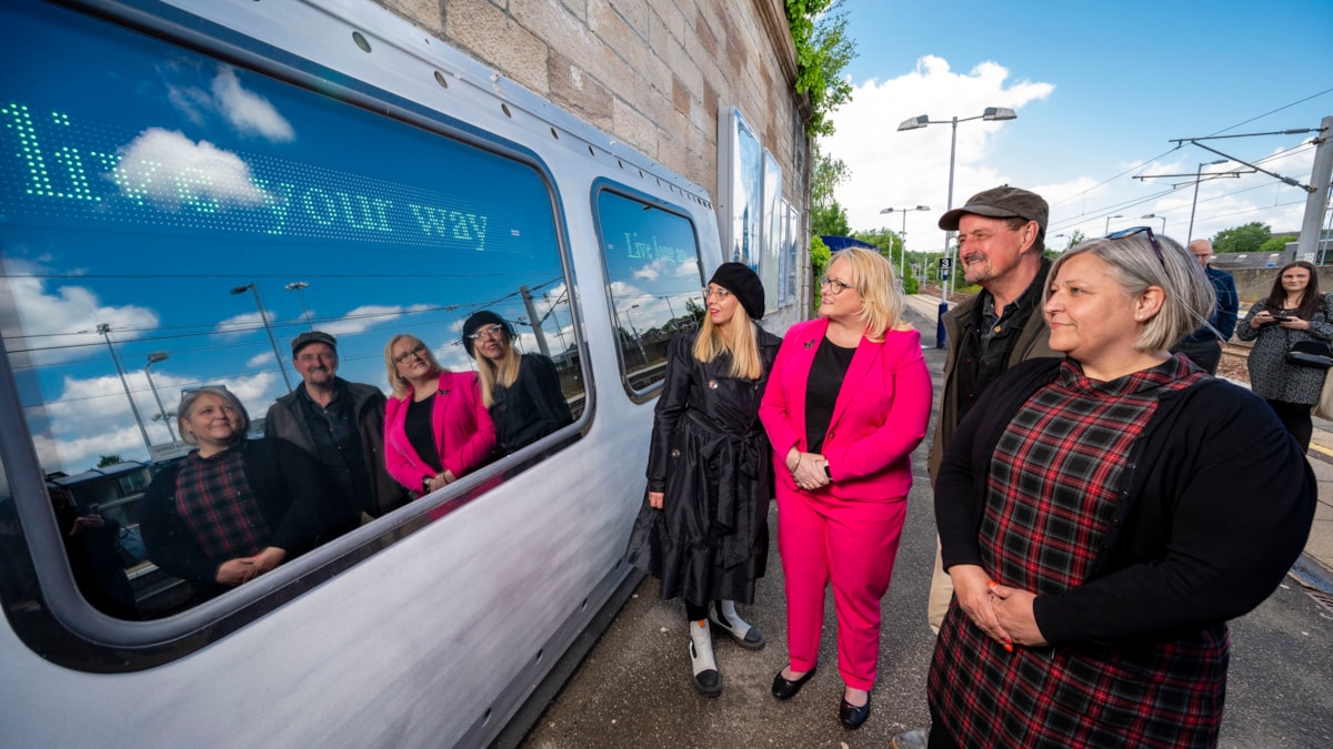 L - R: Suzie McCheyne (Development support at Rail 74 CRP); Christina McKelvie MSP; Rob Mulholland; Joanna Buckley (Avanti West Coast Community Manager) read messages displayed on Hope in Hamilton art installation