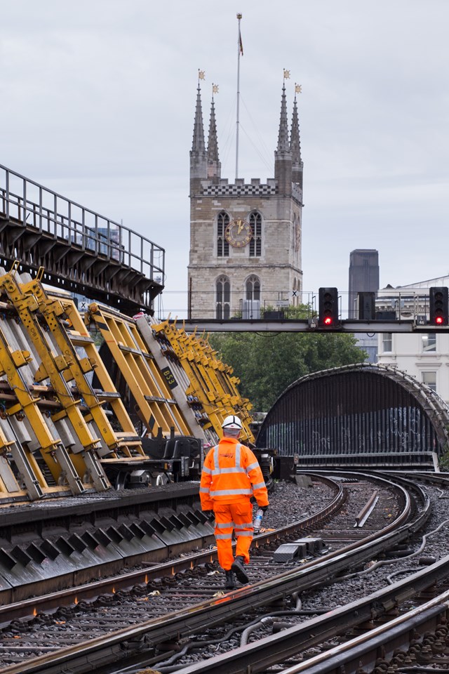 London Bridge August 2015: Southwark Cathedral keeps an eye on Network Rail's tilting wagons - carryring sets of points for Thameslink Programme work at London Bridge