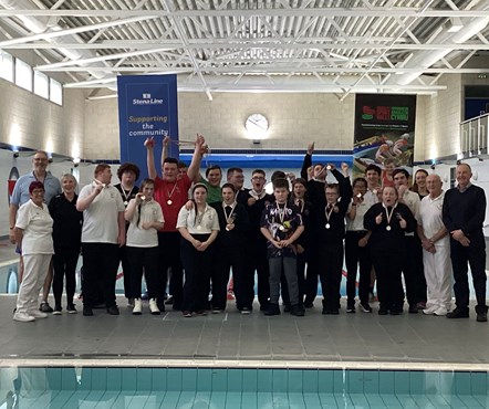 Young people with medals at disability swimming gala Fishguard Pool