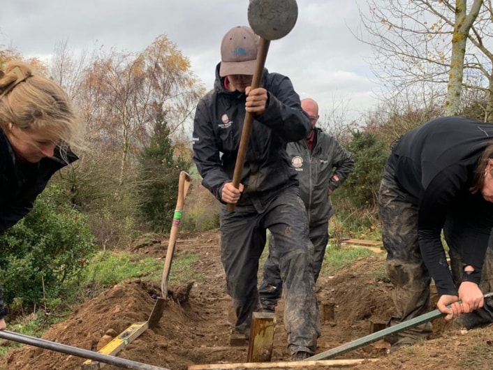 Billie Billington VTL 1: Three people digging a path in the woods.