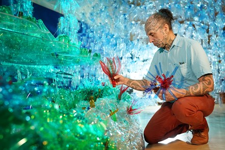 Artist George Nuku puts the finishing touches to the installation of the artwork Bottled Ocean 2123
