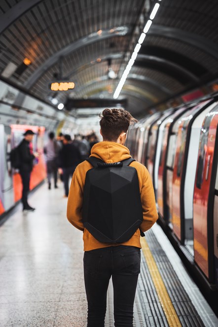 Man on London Underground platform with back to camera