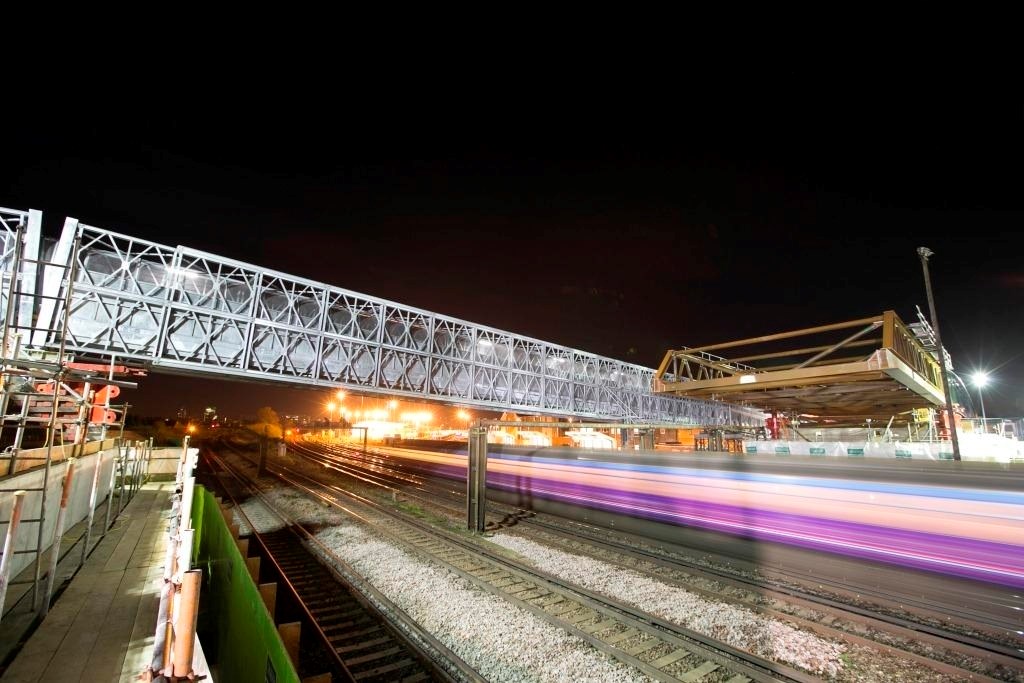TIMELAPSE AND PICTURES: Massive new bridge launched across railway in south London – while trains still run: Tennison Road bridge is jacked into place over the live railway at Croydon