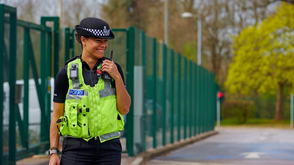 Police officer talking on radio - Hero Image