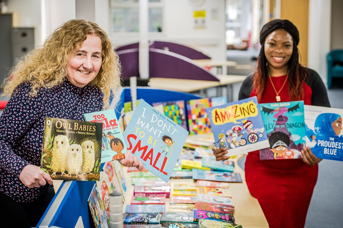Cllrs O'Halloran and Ngongo with books to be donated to Mother Tongue Supplementary Schools
