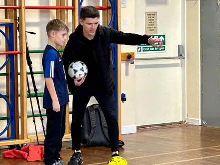 Jags midfielder, Marcus Goodall, shows a P4 pupils at Clunt Primary School how to handle the ball.
