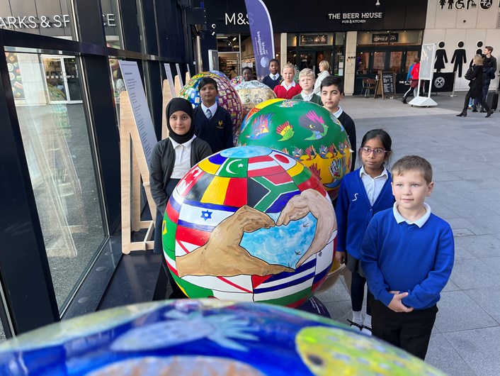 The World Reimagined: Children from Leeds schools who have made the globes now on display at Leeds train station as part of The World Reimagined cultural education project.