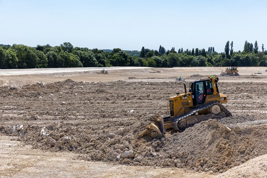 HS2 celebrates first million cubic metres of chalk laid as part of Chiltern grassland transformation: Bulldozer spreading chalk from the Chiltern tunnel - summer 2022