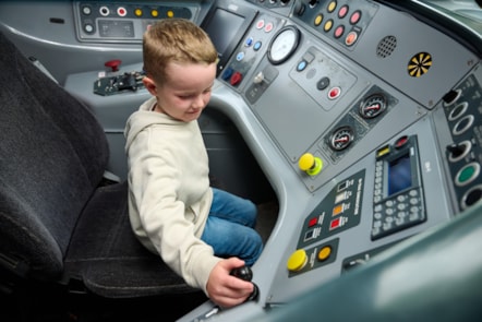 Daniel Rogerson sits inside the driver's cab of a Pendolino, as part of his experience as a rookie trainee driver at Avanti West Coast's driving school.