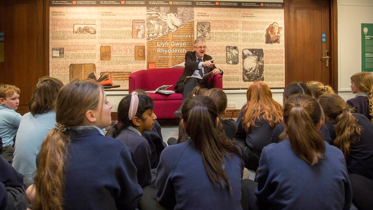 First Minister reads extracts of the Mabinogion to school pupils in the national Library of Wales ahead of World Book Day