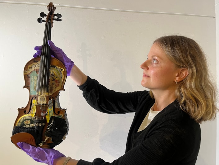 Music Leeds Us: Leeds City Museum's exhibitions curator Laura Irwin with a violin used by The Legendary Len Liggins, a member of Leeds band The Ukrainians.