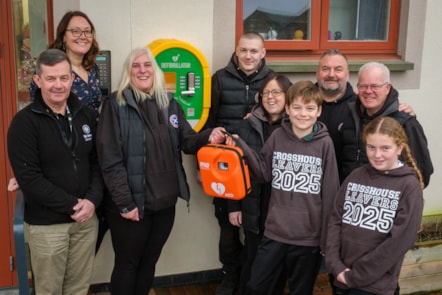 Carol Paton from Mobityres hands over the new defib at Crosshouse Primary