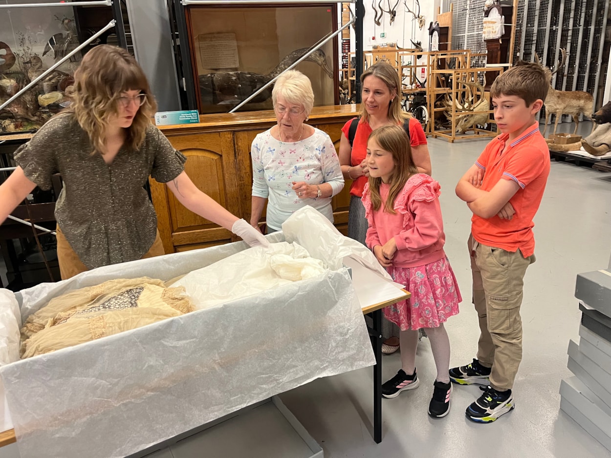 Lily Cathcart wedding dress: Sara Merritt (far left), Leeds Museums and Galleries' audience development officer, shows the precious wedding dress to (L-R) Jennifer Slater, Christina Bromley, Emmeline Bromley and Alexander Bromley, the family of Lily Cathcart.