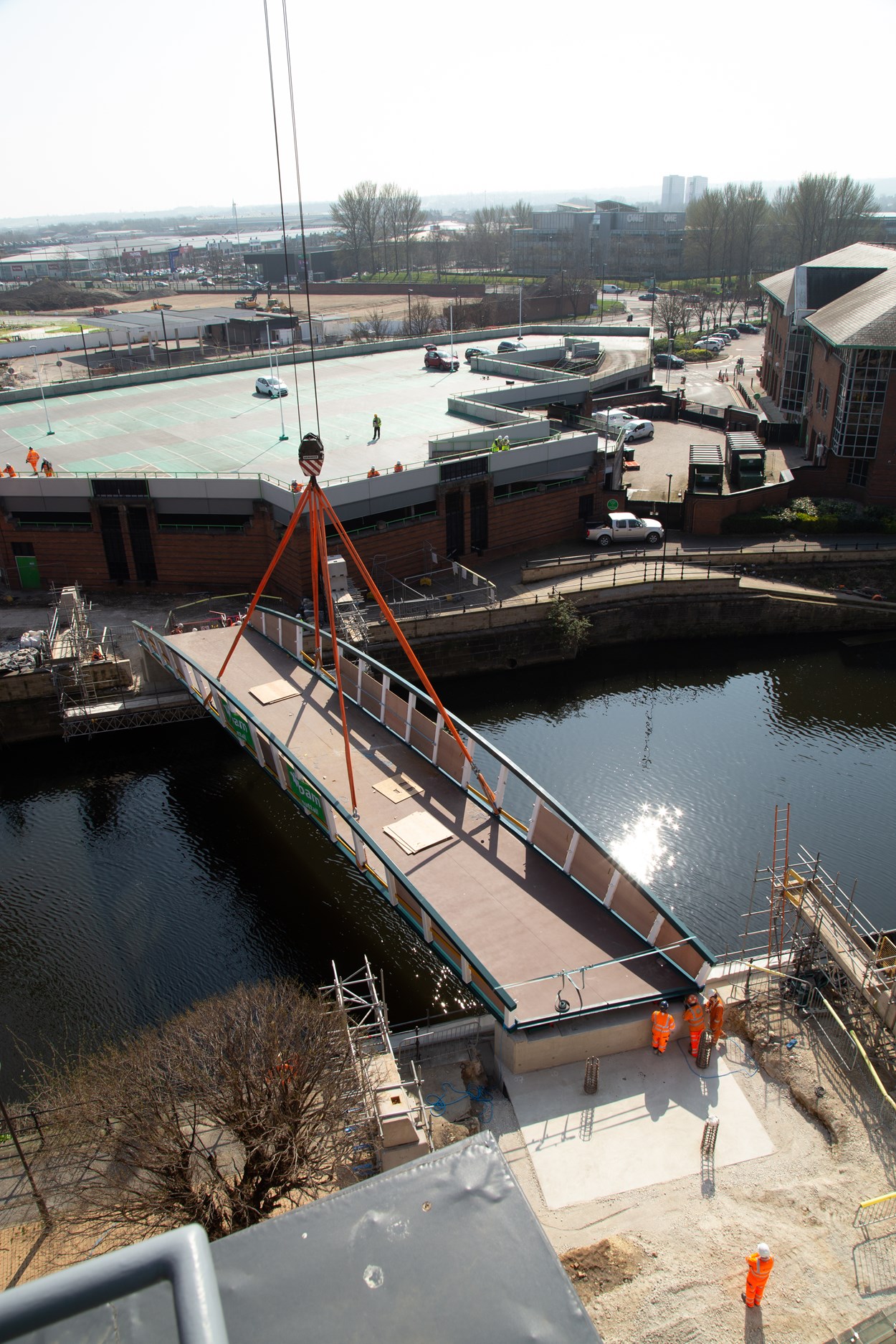 David Oluwale bridge installation: The David Oluwale bridge is lifted into place over the River Aire in Leeds. Engineers working on the David Oluwale bridge completed one of the project’s major milestones over the weekend, with cranes carefully placing the 40 tonne structure over the river where it will connect Sovereign Street to Water Lane. Credit BAM Nuttall.