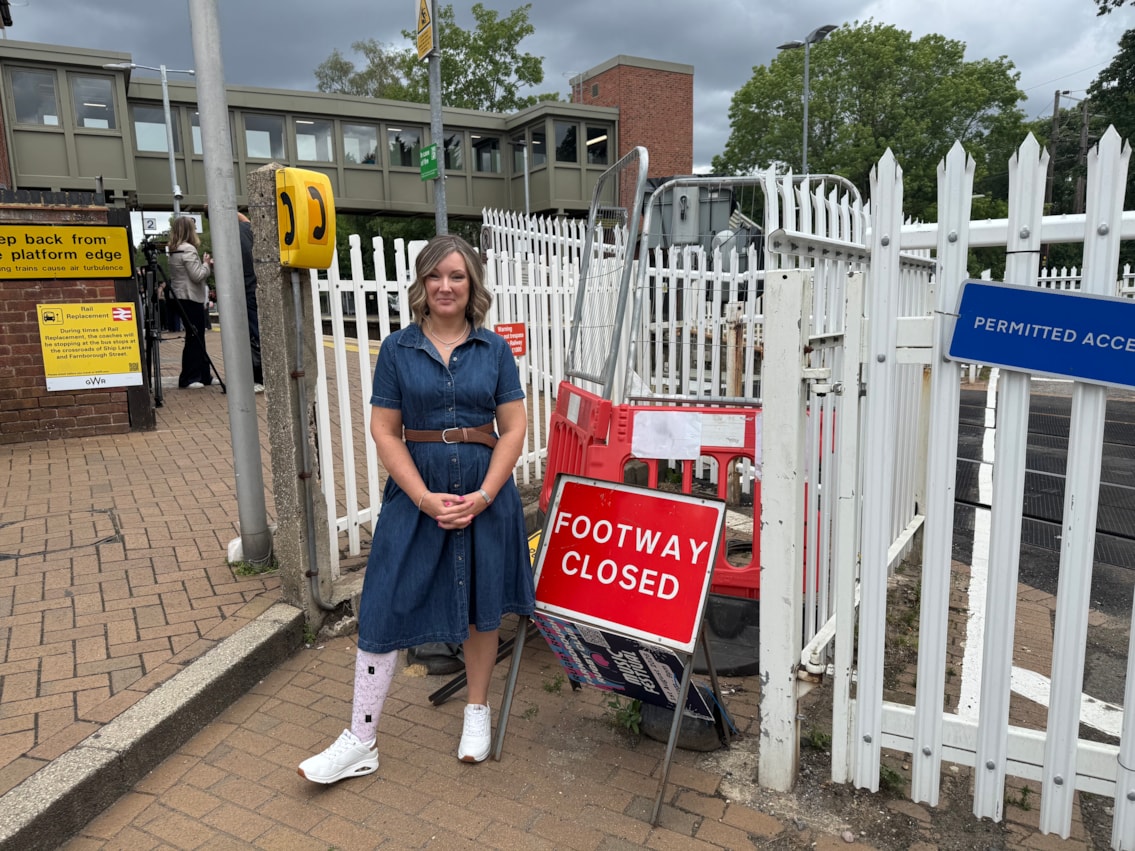 Lucy Ruck in front of the closed level crossing sign