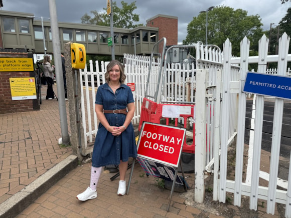 Lucy Ruck in front of the closed level crossing sign