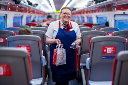LNER COLLEAGUE DELIVERING HOT DRINK AND MUFFIN TO SEAT