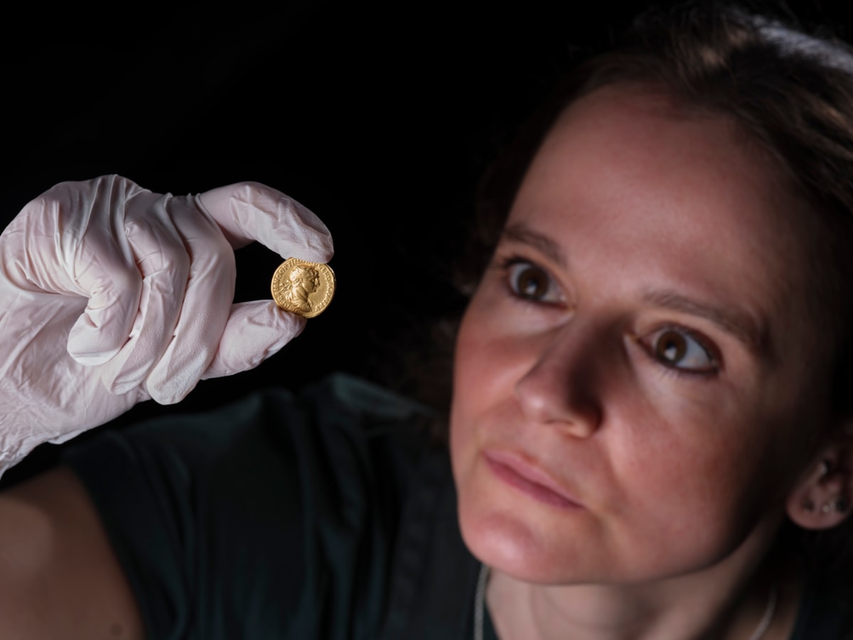 Conservator Bethan Bryan examines the gold Aureus of Trajan. Image © National Museums Scotland (2)