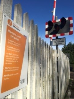 An information sign at Marston level crossing