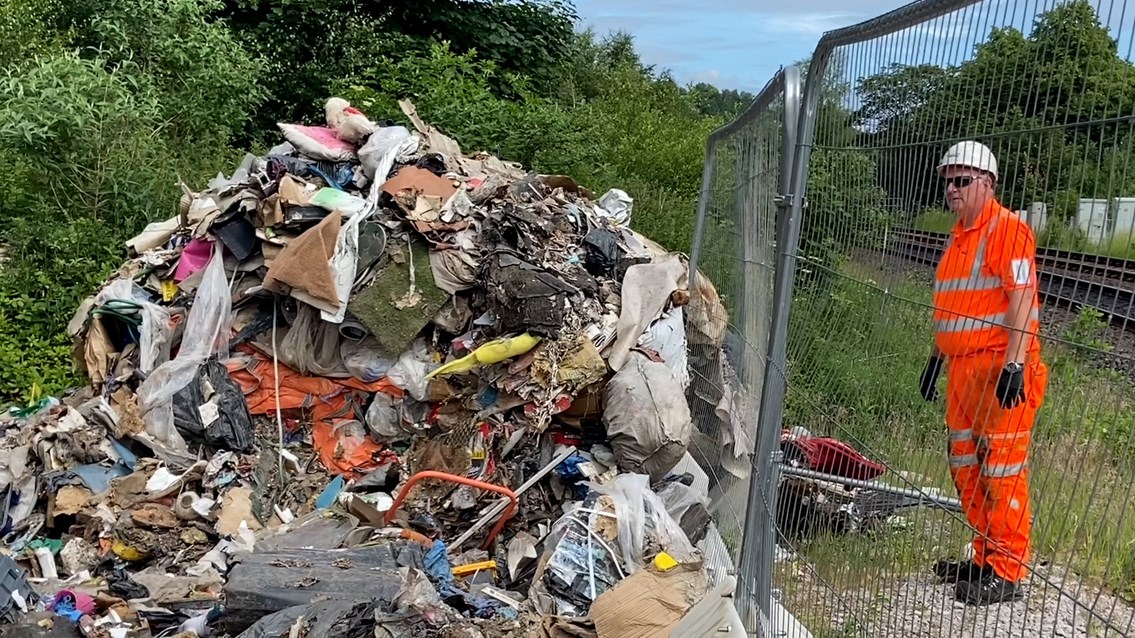 The pile of rat infested fly tipping left to rot beside the railway in Stalybridge