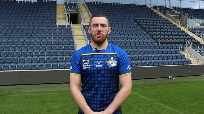 Suicide Prevention Champions - Cameron Smith: Cameron is pictured standing on the rugby pitch, looking at the camera, in his Leeds Rhino kit