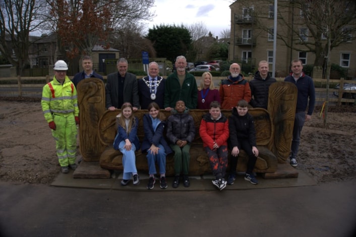 Otley bench unveiling group: Group photo of people involved in the carving of a new oak bench unveiled in Tittybottle Park, Otley