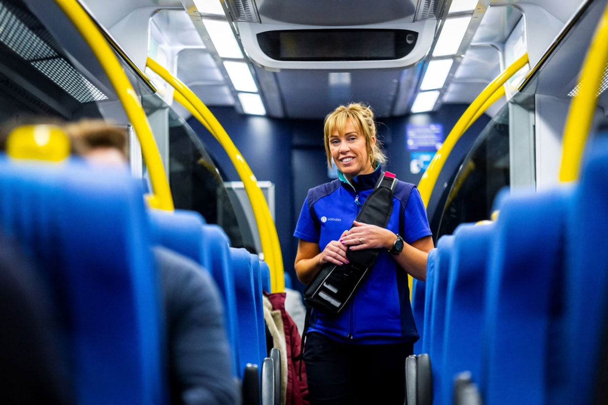 Image shows female conductor on-board Northern train