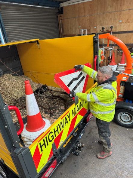 Arborists in LCC's highways team prepare for the storm by putting signs in a van