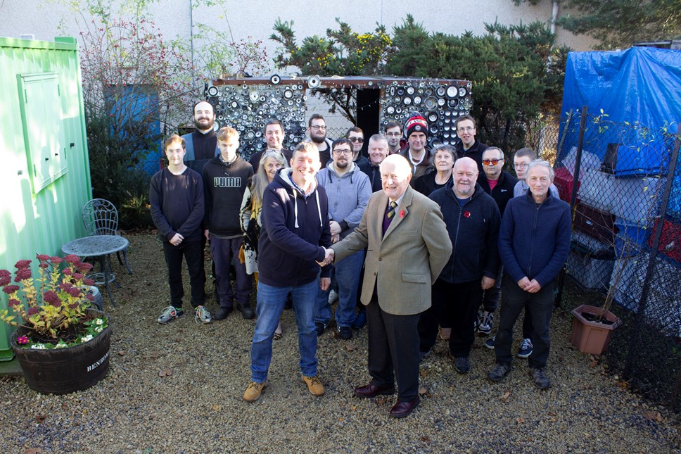 The Lord Lieutenant of Moray, Major General Seymour Monro CBE LVO (front right) congratulates ReBOOT manager Lee McGrath (front left) and his team for their award.