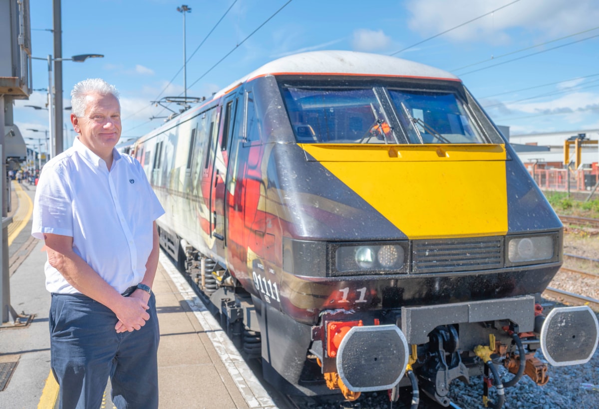 Nick Dudley, alongside a LNER Class 91 locomotive