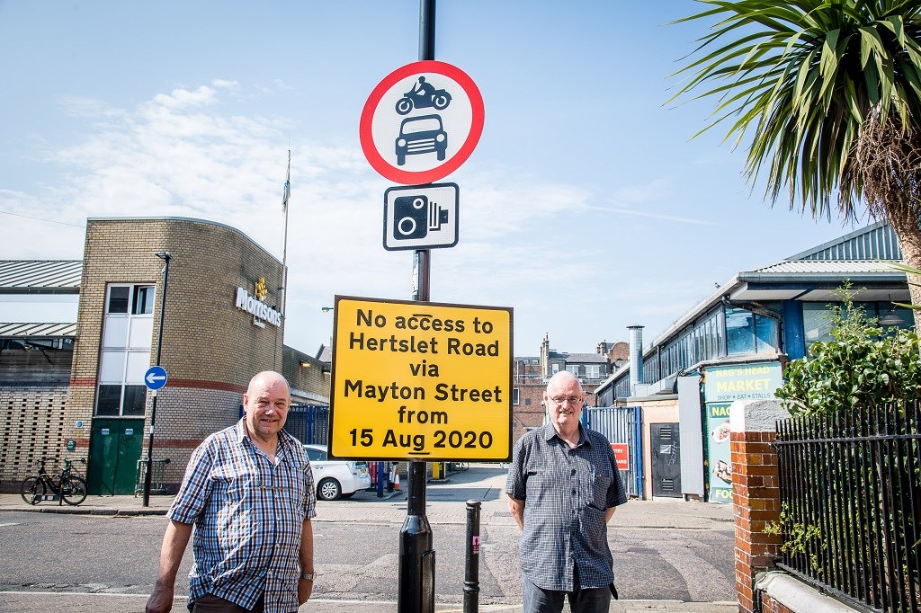 Cllr Michael O'Sullivan (pictured right) and Cllr Gary Heather (left) with new signage announcing measures to make Mayton Street greener, safer and more pleasant