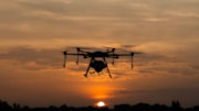 Drone flying at sunset cropped: Drone flying at sunset cropped
