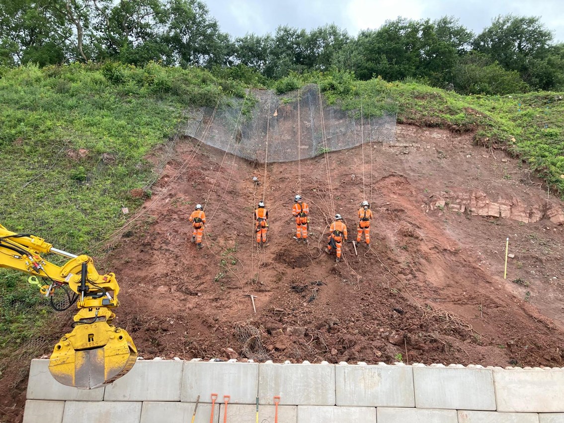 Rope workers abseiling down face SERP 2023