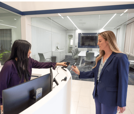 women trying to get into a building by scanning ID