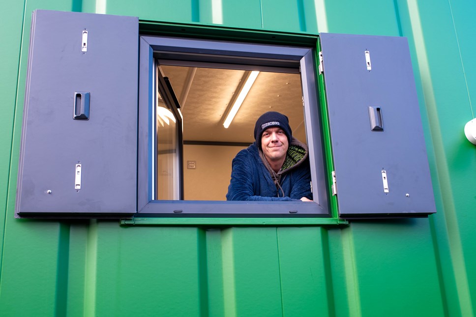 Formerly homeless Jamie looks out of the window of his new modular home in Reading. Credit: Jo Lenny/St Mungo's