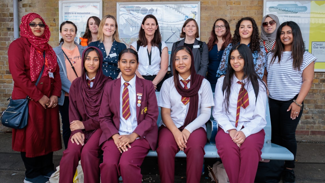 Train networking event inspires next generation of women in rail: Group of rail engineers and schoolgirls at Canterbury East station
