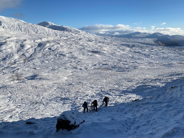 Carrying materials for the exclosures uphill to the planting site ©Natalie Ward/NatureScot
